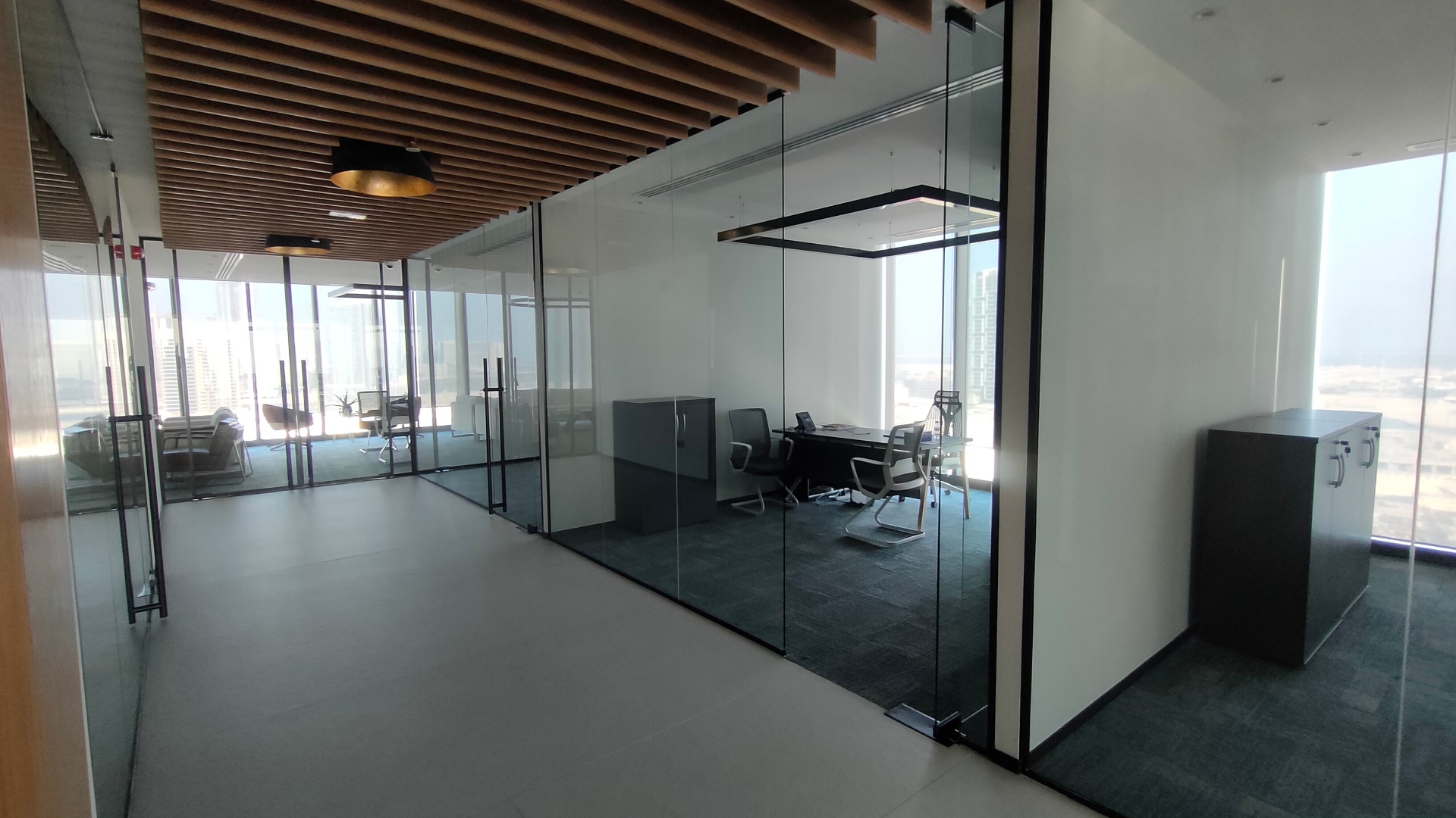 Curved glass partition design in a premium Dubai office reception