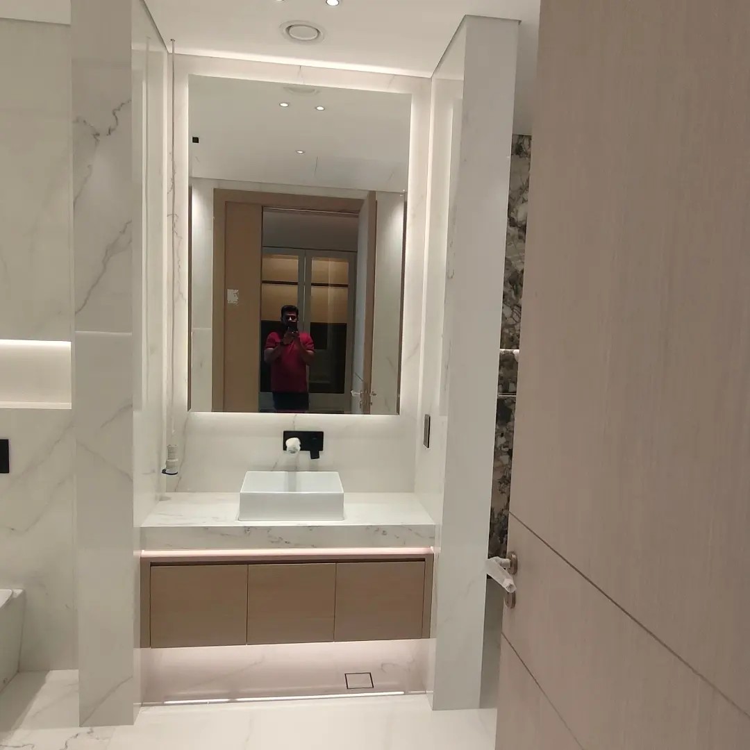 frameless backlit vanity mirror marble bathroom Dubai